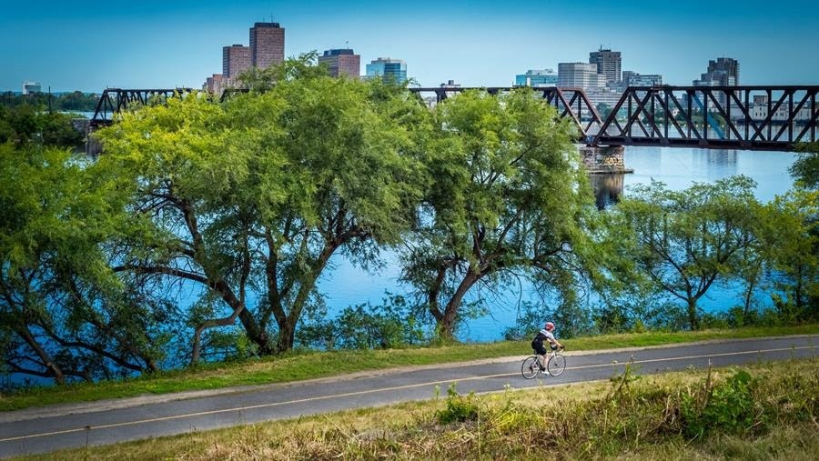 Biking along Ottawa River Pathway West with Prince of Wales Bridge